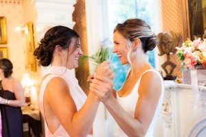 bride and bridesmaid jump in pre-wedding excitement