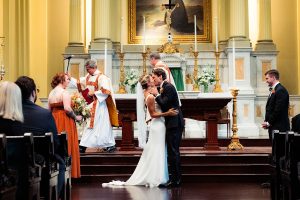 Bride and groom first kiss at the alter