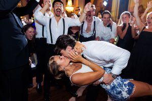 Groom dips bride in her second outfit at the end of the night