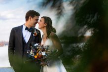 Couple goes in for an almost-kiss during the portrait portion of their fall London Town wedding.