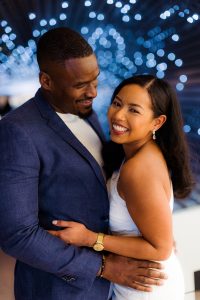 Couple poses for engagement photos in the east wing of the DC National Gallery of Art.