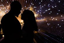 A couple is silhouetted by the lights of the Multiverse light installation at the National Gallery of Art in DC.