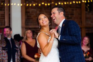 Bride and groom share a laugh during their first dance at the AVAM in Baltimore.