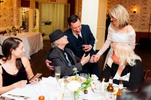 Bride and groom go around to tables to greet their guests at their rainy Mount Vernon Inn Restaurant wedding.