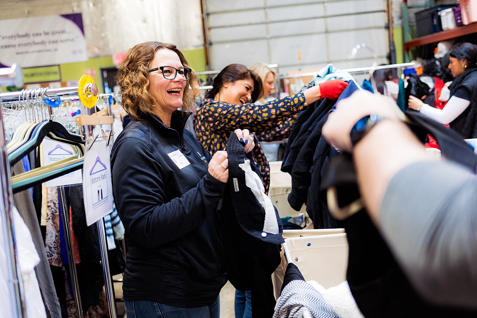 A volunteer sorts and sizes clothing at a corporate volunteer event in Sterling, Virginia. 