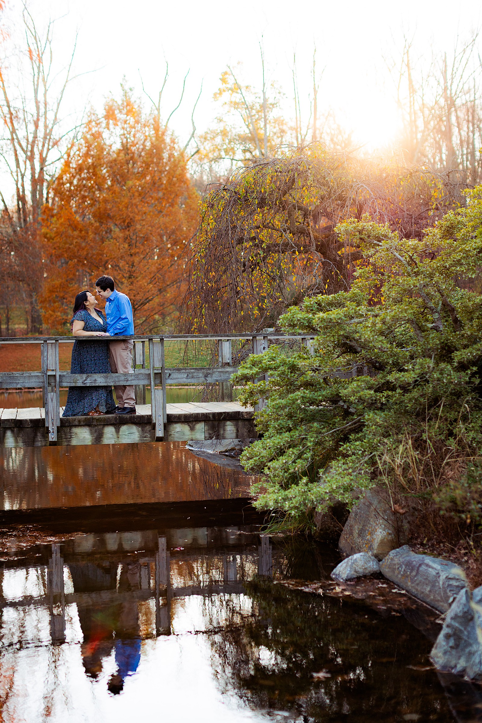 A couple kisses on a bridge at Brookside Gardens.