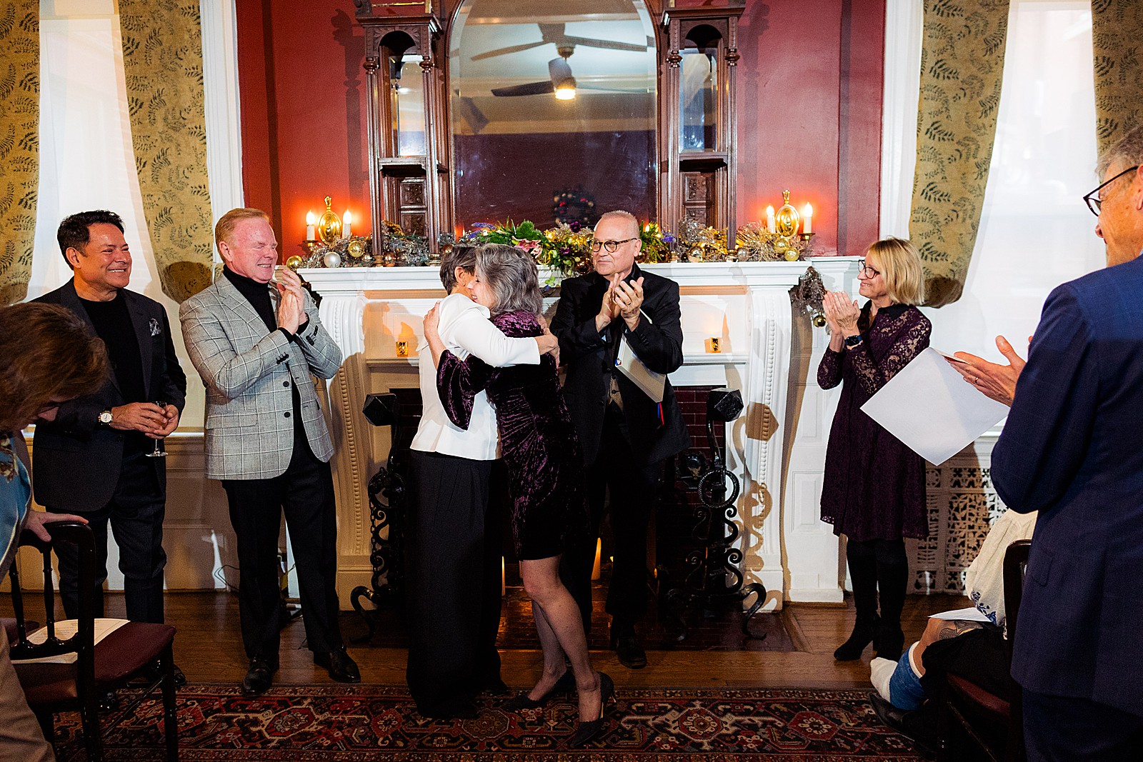 Two brides hug and embrace to celebrate finally being married at the end of their ceremony at the Tabard Inn. 