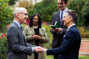 Grooms exchange rings during an elopement at Bishop's Garden in DC.